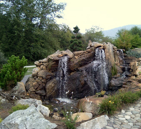 Custom tiered waterfall water feature by WNC Landscaping