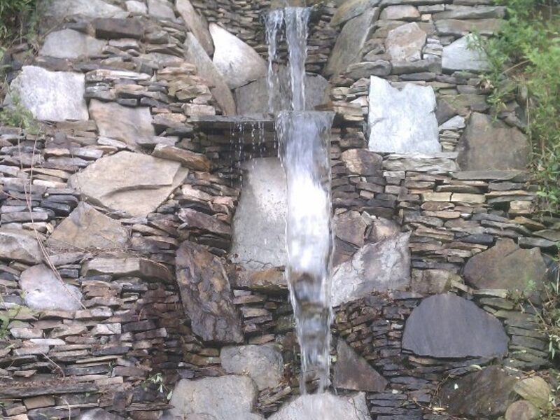 Custom stacked-stone waterfall built by WNC Landscaping