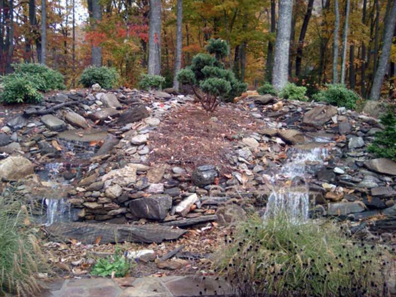 Rock water feature with dual cascades by WNC Landscaping